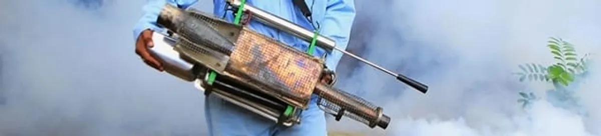 Fumigation technician using a fogger for deep pest treatment in Miami, FL